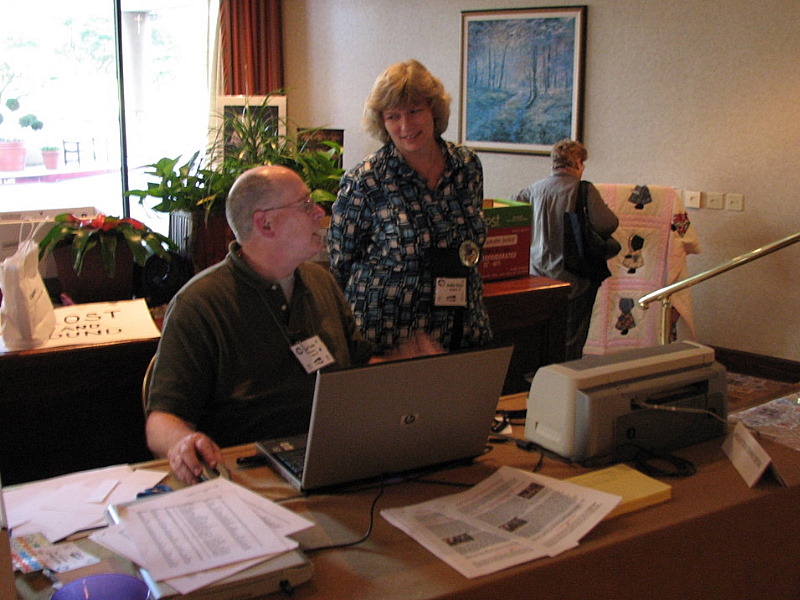 Ken Fuchs discusses registration with Debbie Hughes, co-chair of the 2009 convention in Kansas City